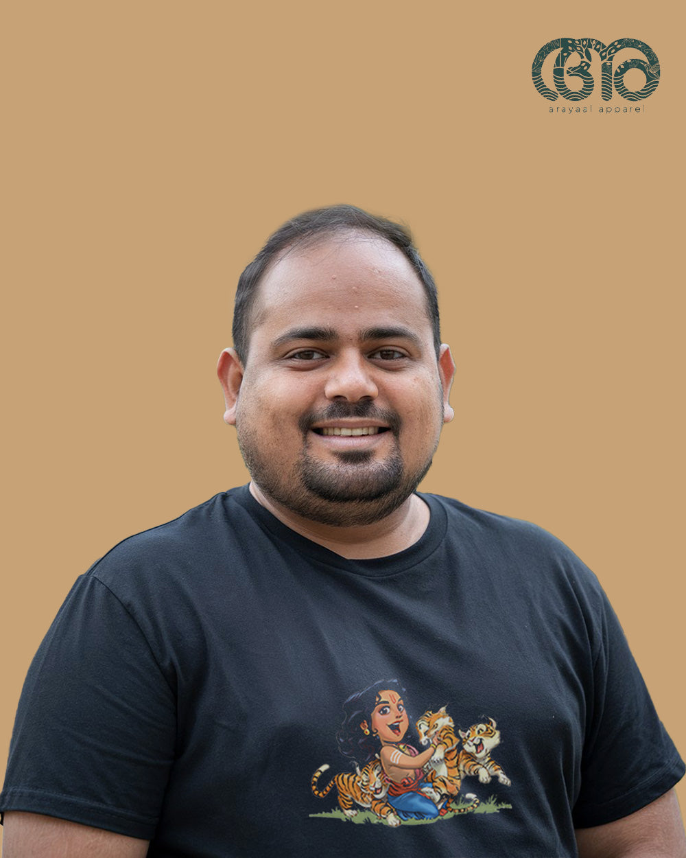 Man wearing a black Arayaal Store T-shirt dedicated to Sabarimala pilgrimage.